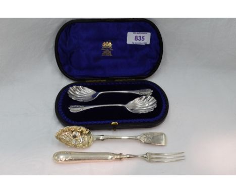 A cased pair of Victorian silver jam spoons having scalloped bowls and embossed terminals, London 1895, Josiah Williams &amp;