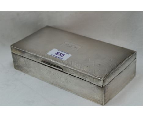 A silver cigarette case having engine turned decoration to lid with monogrammed cartouche and presentation inscription to sid