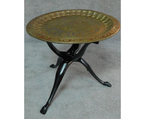 An Eastern polychrome brass tray on carved tripod stand. H.50 W.60 D.60 