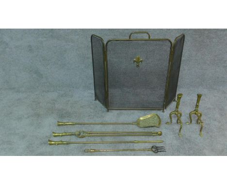 A set of 19th century brass fire implements and the matching andirons and a three section fireguard. H.61 (fireguard) 