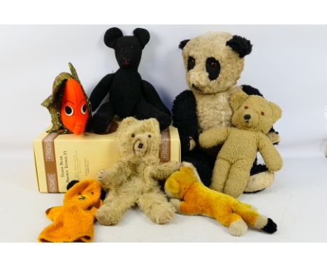 Teddy Bears - A group of vintage soft toys including a large Panda, a Sooty glove puppet, a floral elephant and others. They 