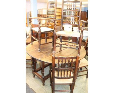 An oak gateleg table with eight dining chairs