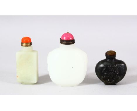 A MIXED LOT OF 3 CHINESE CARVED JADE SNUFF BOTTLES - each of varying medium and style - one carved with dragons, one with a b