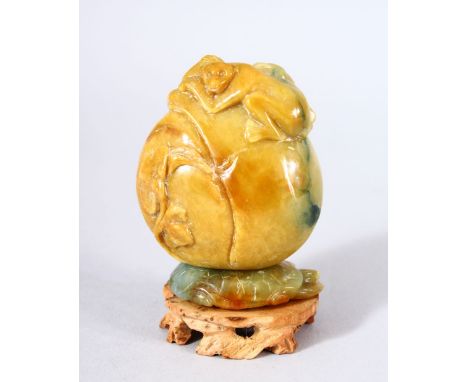 A GOOD CHINESE CARVED JADE MONKEY, PEACH &amp; LOTUS SNUFF BOTTLE AND STAND - the upper part carved with a money lying upon a