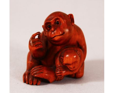 A JAPANESE CARVED WOODEN NETSUKE OF TWO MONKEYS - one seated monkey with its young, signed underside reading " Matsatsugo" - 