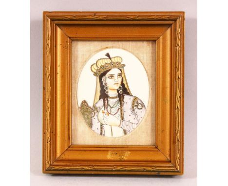 A 19TH CENTURY INDIAN IVORY SLITHER PAINTING OF A FEMALE - the female with head dress and gowns, framed in gilt mounted frame