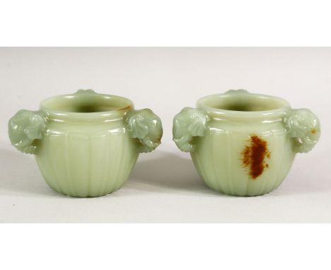 A GOOD SMALL PAIR OF CARVED JADE CIRCULAR RIBBED CENSERS, with three elephant formed handles, 8cm diameter.