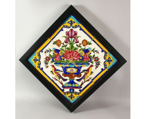 A 19TH CENTURY PERSIAN QAJAR TILE PANEL, comprising four square tiles forming a picture depicting an urn of flowers and exoti