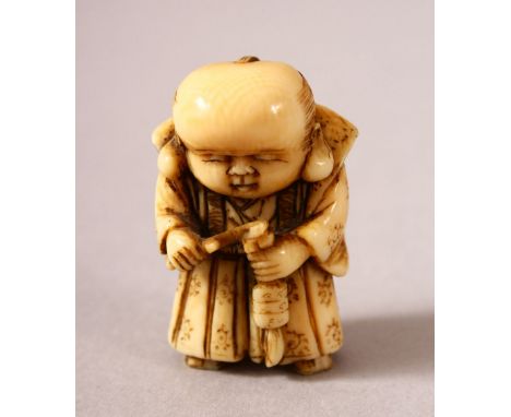 A JAPANESE MEIJI PERIOD CARVED IVORY NETSUKE OF A BOY - the boy stood holding and looking down at his inro 3cm