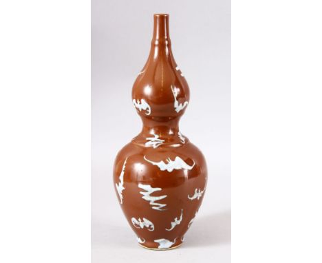 A CHINESE BROWN GLAZED DOUBLE GOURD PORCELAIN BAT VASE - decorated with many bats upon a cafe au lait glaze, the base with an