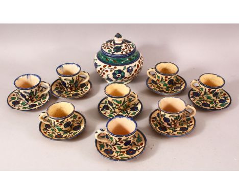 A SET OF EIGHT PALETINIAN JERUSALEM POTTERY COFFEE CUPS AND SAUCERS, together with a sugar bowl, with floral decoration, eigh