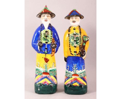 A PAIR OF 20TH CENTURY CHINESE FAMILLE ROSE PORCELAIN OFFICIAL FIGURES, of two standing officials, Each with a pressed seal m