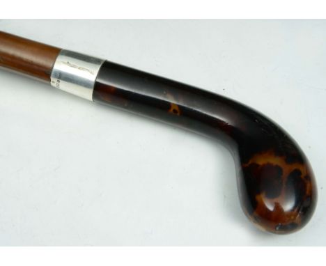 A MALACCA WALKING STICK with tortoiseshell handle and silver ferrule, hallmarked London 1924, makers mark C.C., 92cm long