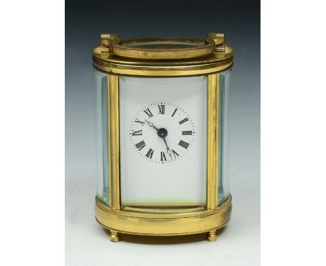 A MINIATURE BRASS CASED OVAL CARRIAGE TIMEPIECE with white enamel dial and Roman numerals, 8cm high