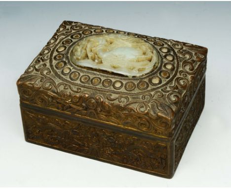 A CHINESE GILT METAL RECTANGULAR BOX AND COVER, relief decorated with dragons and scrolling foliage, the lid inset with a car
