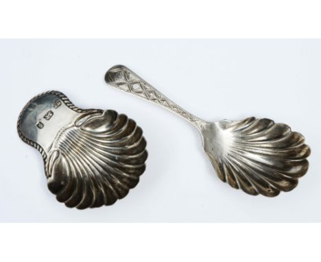 A GEORGE III SILVER CADDY SPOON with a shell shaped bowl and gadrooned handle, 6.2cm long, London 1780 by Tudor & Leader; a f