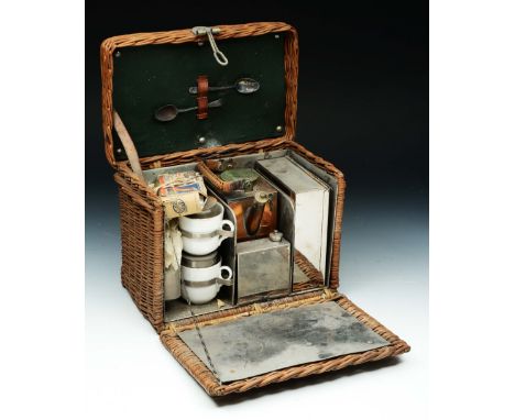 AN EARLY 20TH CENTURY WICKER SMALL PICNIC HAMPER, the fitted interior with square section copper kettle, and other accessorie