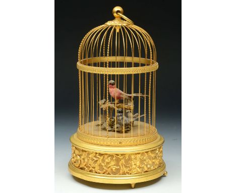 A SWISS GILT METAL MUSICAL SINGING BIRD AUTOMATON, the two feathered birds within domed cage, with key wound movement to the 