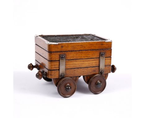 A LATE VICTORIAN OAK AND SILVER MOUNTED NOVELTY CIGAR BOX in the form of a steam engine tender with hinged rising lid and hal