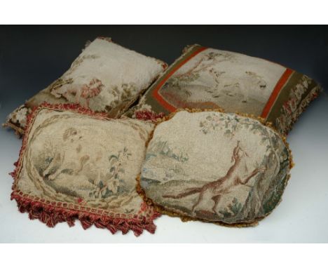 A GROUP OF FOUR ANTIQUE AUBUSSON TAPESTRY COVERED CUSHIONS with varying decoration, largest 42 x 46cm (4)