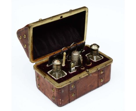 A LATE VICTORIAN LADIES ETUI in the form of a travelling trunk with fitted interior with twin scent bottles, mirror, scissors