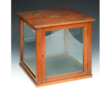 A SATINWOOD BIJOUTERIE CABINET with painted ribbon swag and cherub decoration, one glass shelf, 30cm square x 31cm high