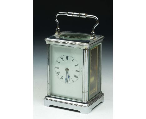 A SILVERED CASED CARRIAGE CLOCK with swing handle and white enamel dial, the eight day movement striking on a gong, 13cm high
