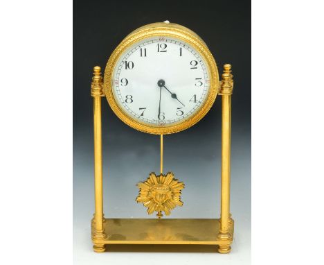 A FRENCH GILT METAL PORTICO TIMEPIECE, with white enamel dial, on four pillar supports with sunburst pendulum, 21.5cm high