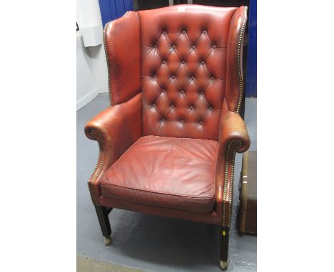20th Century leather button back Chesterfield style wing chair on casters.(B.P. 24% incl. VAT)