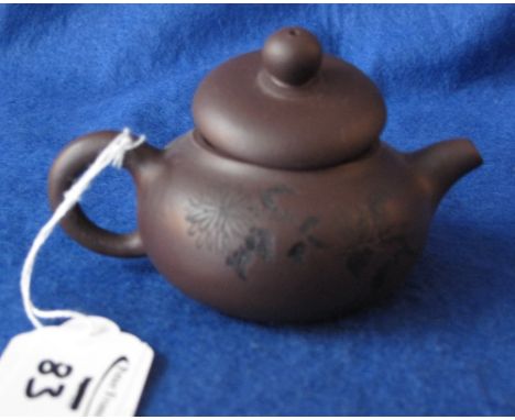 Tiny Chinese Yixing style terracotta teapot with floral spray to one side and character marks to the other and having four ch