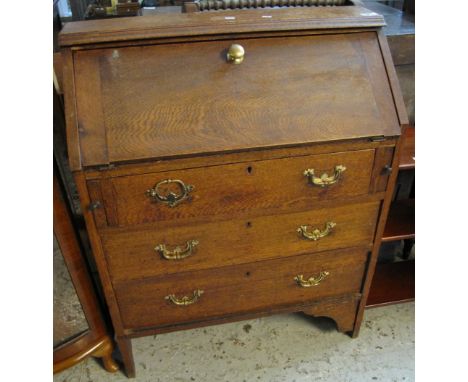 Early 20th Century oak fall front bureau having three long drawers on bracket feet. (B.P. 24% incl. VAT)