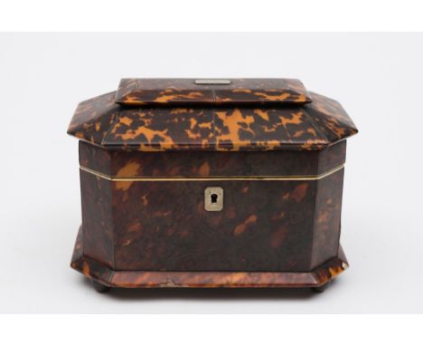 A 19th century tortoiseshell tea caddy: of rectangular outline with canted corners, the shallow domed lid enclosing two lidde