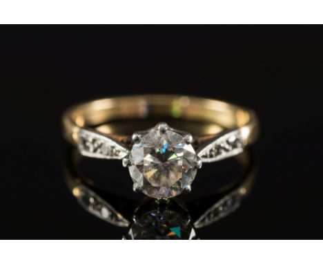 A diamond single-stone ring:, the circular brilliant-cut stone approximately 0.7ct in rex claw setting between diamond two-st