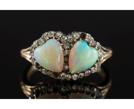 A gold, opal and diamond mounted double heart-shaped cluster ring:,  each heart-shaped opal approximately 8mm long x 7mm wide