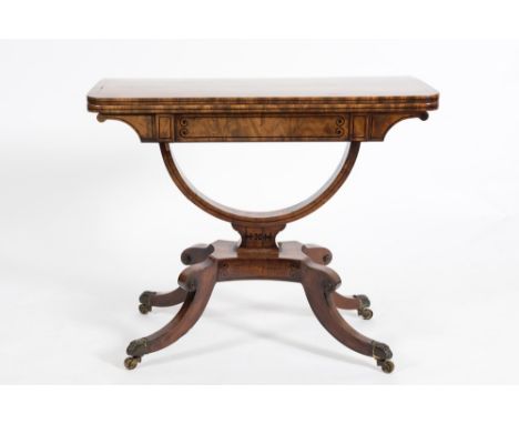 A Regency mahogany and ebony strung card table:, the rectangular baize lined hinged top with rounded corners, having a U shap