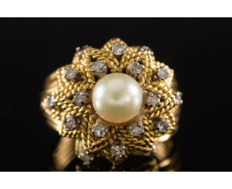 A cultured pearl and diamond cocktail ring: the central cultured pearl within a surround of single-cut diamonds upon a gradua