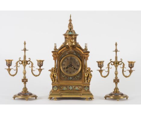 Japy Freres, Paris, a gilt brass and champleve enamel three-piece clock garniture:, the eight-day duration movement striking 