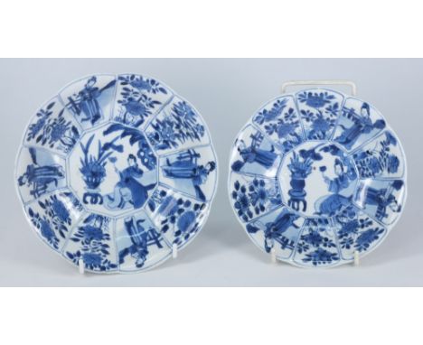 Two Chinese blue and white moulded dishes: each painted with panels of flowering plants and ladies in garden settings, one wi