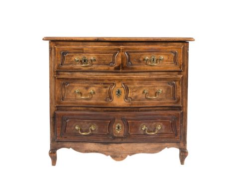 An 18th Century French provincial walnut serpentine fronted commode:, the top with a moulded edge, containing two short and t