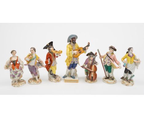 A late Meissen Commedia dell'Arte figure, two similar monkey band figures and four others: the first after Kandler of the mas