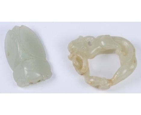 A Chinese jade carving of a coiled dragon and a pendant in the form of a cicada: the dragon clasping it's tail, the stone of 