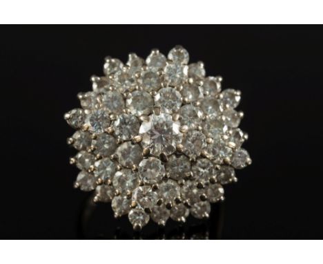 A diamond circular cluster ring:, the central diamond estimated to weigh approximately 0.45ct, within a surround of graduated
