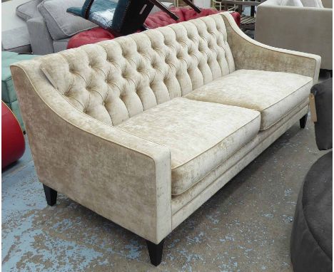 BESPOKE SOFA, two seater, in dark cream button back on ebonised supports, 190cm L.