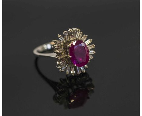 A RUBY AND DIAMOND CLUSTER RING, circa 1960 the oval shaped ruby of pretty colour weighting approx 2.80 carats within a balle