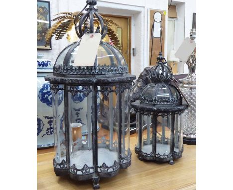 STORM LANTERNS, graduated pair, Georgian design, lined concave glass, metal frames, largest 56cm H, other 43cm H. (2)