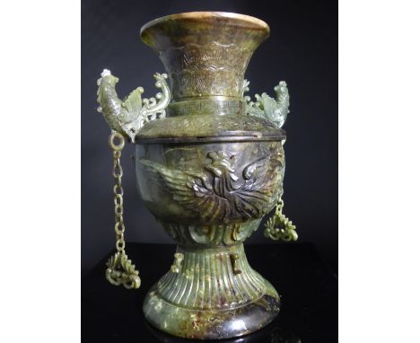 An Antique Chinese Translucent Jade Urn, the urn of baluster form having ornately carved phoenixes in flight to either side, 