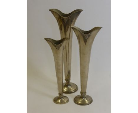 Three Silver Metal Graduated Stem Vases for a centre piece together with a candle stick.