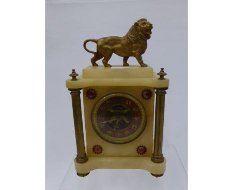 A Marble Style Mantle Clock, with red enamel dial, Corinthian column support with a lion mounted to top.