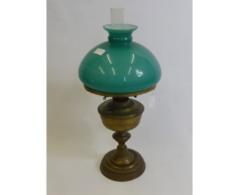 A Victorian Brass Oil Lamp, with green shade and original glass funnel.