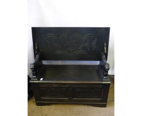 A Vintage Mahogany Monk's Bench, with decorative arm rests in the form of recumbent lions, approx 104 x 42 x 107 cms.